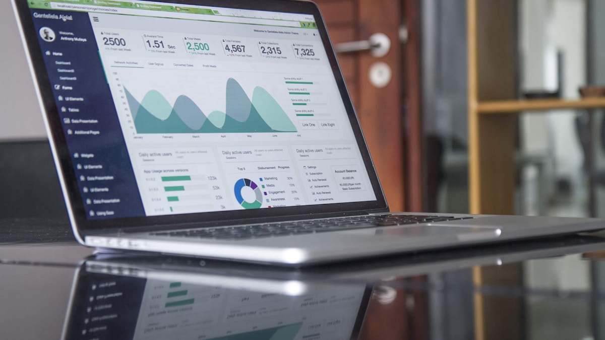 Gráficos financeiros, calculadora e planilha de precificação sobre mesa de planejamento de oficina
